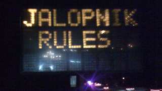 Jalopnik-Hacked Road Sign: We're All Going To Jail Now